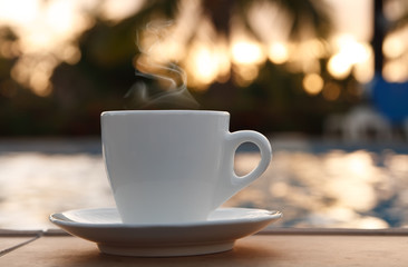 espresso coffee cup on golden sunset background