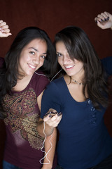 Two young women listening to music