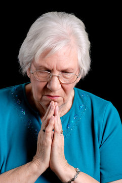 Senior Woman Praying On Black