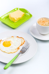 breakfast meal - fried egg on white plate with coffie