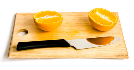 still life with orange, knife and wood plate