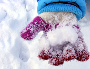 Hand with glove and snow