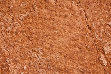 A mottled and cracked sandstone surface