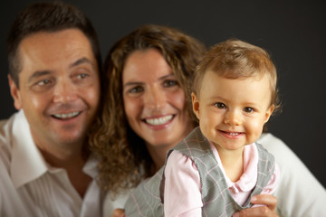 happy baby in front of her parents