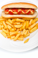 classic hot dog with mustard and ketchup and french fries