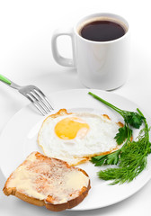 breakfast meal with fried egg and a large mug of black coffee