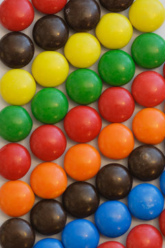 colorful candy in diagonal rows on white