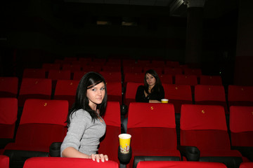 girl is in cinema, look a film