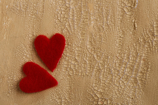 two fluffy hearts on cracked painted background