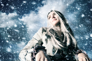 Young blond woman in a blizzard