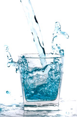 Glass of pouring water with reflection