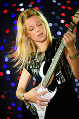 Female guitar player on stage