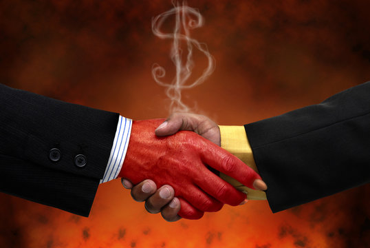 Businessman making a pact with the devil