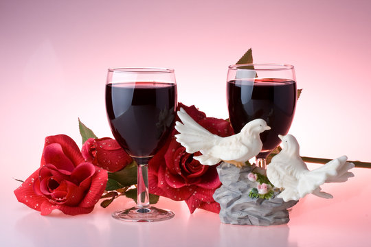 Two glasses of wine, rose and figurine