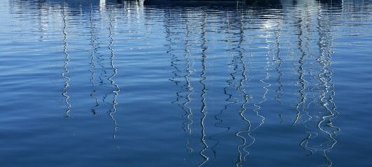 Boats abstract reflexion over blue water