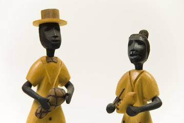 wooden figures of a man and woman playing musical instruments