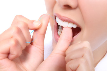 Obraz na płótnie Canvas Woman Flossing Her Teeth