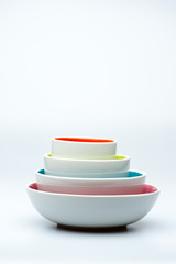 4 nested white bowls on white background