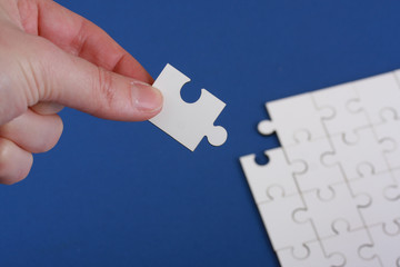Hand holding corner of jigsaw