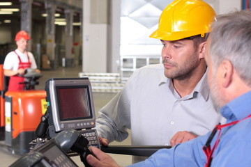 supervisor talking to engineer in warehouse