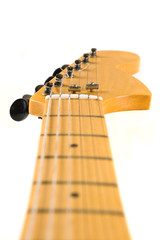 Head and neck of an electric guitar.