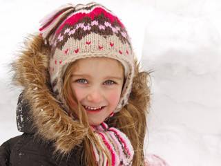 girl playing in the snow