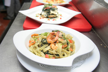 fettucine marinara seafood, lasagna at background