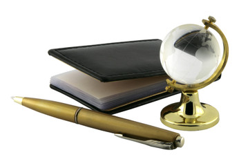 Notepad, pen and glass globe.