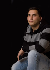 Young man thinking on a black background