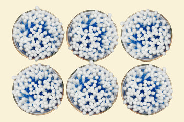 Cotton sticks on a yellowish background