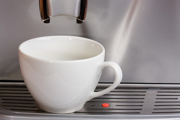 Waiting for coffee. Empty cup in espresso coffee machine