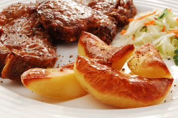 Grilled meat with baked potatoes and vegetable salad
