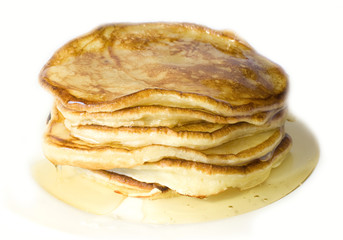 Pile of home-made pancakes with honey on white background