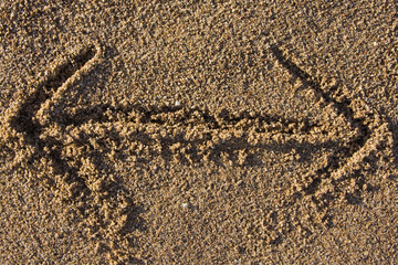 arrow sign in sand