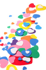 colorful foam confetti hearts over white background