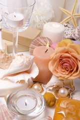 Candle, mussels, bath accessories and rose