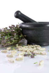 Herbal pills, dry thyme and mortar