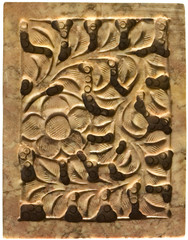 Floral design carved into a light stone panel