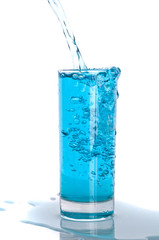 Glass of pouring water with reflection
