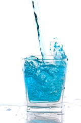 Glass of pouring water with reflection