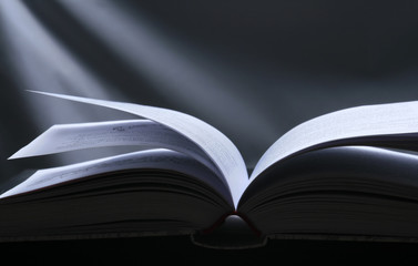 Opened Book. Black background with Magic Light.