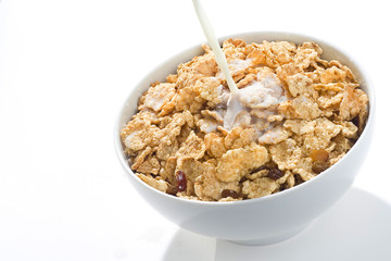 bowl of cereal with raisins and milk