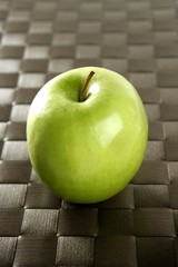 apple on a brown tablecloth