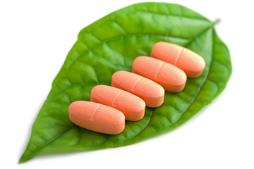 macro of prescription pills over green leaf isolated