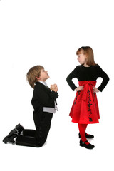 children in formal clothing mimicing adult proposal behavior