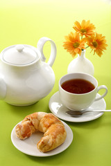 Breakfast concept with coffee and croissant