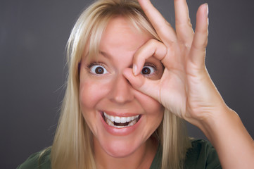 Woman with Okay Sign in Front of Face