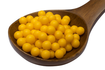 Yellow pills on spoon