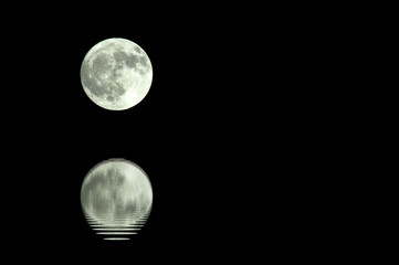 Moon is reflected on the surface of the water.