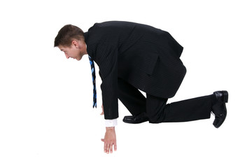 Businessman getting ready for race in business